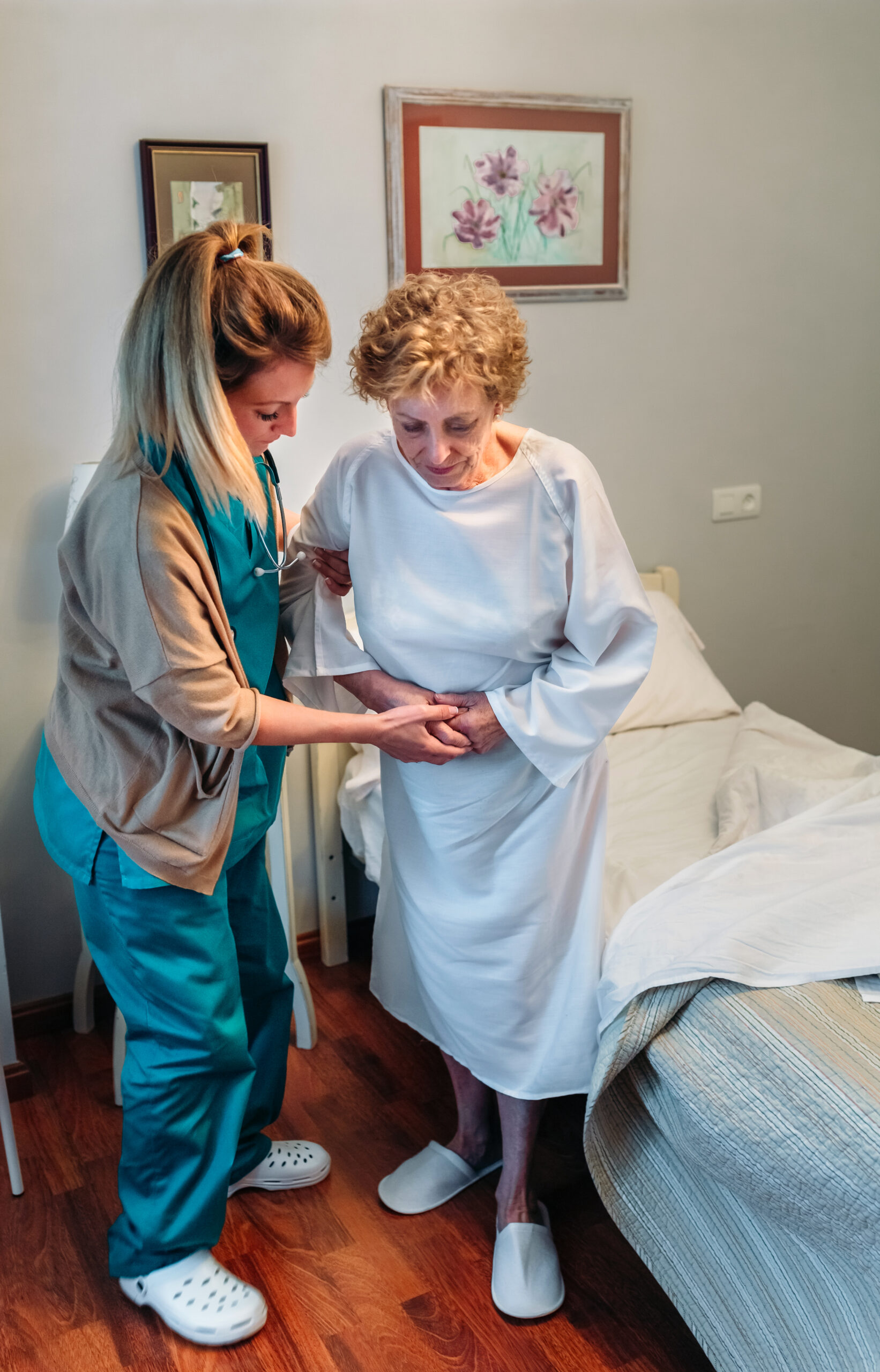 Caregiver helping elderly patient to stand up